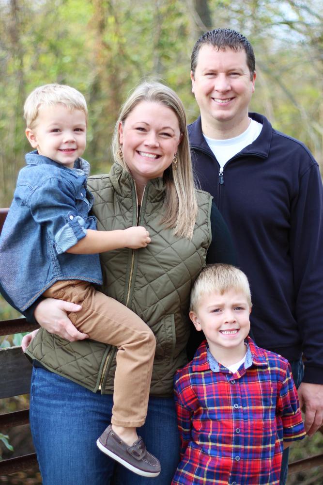 Katie Bonnema Poses with her husband and two children. Bonnema spends time with her family and goes to her boys sports games.