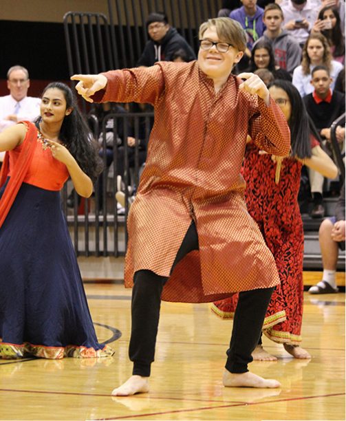 Demonstrating his personal cool vibe, even in a tunic, junior Jack Mahony performs with the Bollywood Dancers at the 2018 Diversity Assembly on Jan. 29