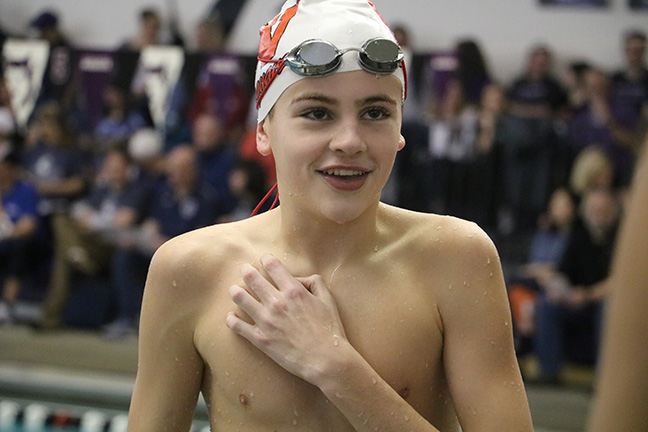 Happy with his time drop in the 50 freestyle at the Greg House Invite on Jan. 13, freshman Chase Meatheany smiles before he visits Coach Sample. 