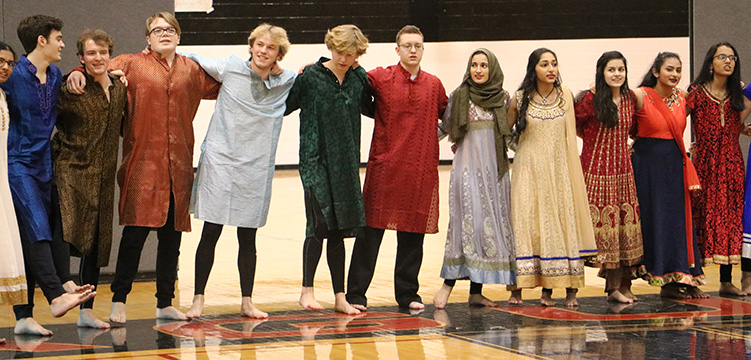 The Bollywood dancers lock arms to sing the alma mater at the Jan. 29.