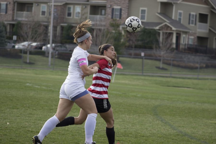 Sophomore Alexis Christopherson battling North soccer player to obtain the ball.