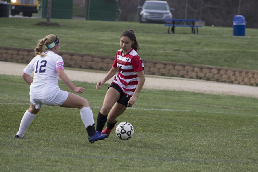 Sophomore Alexis Christopherson battling for the ball, determined to score. 