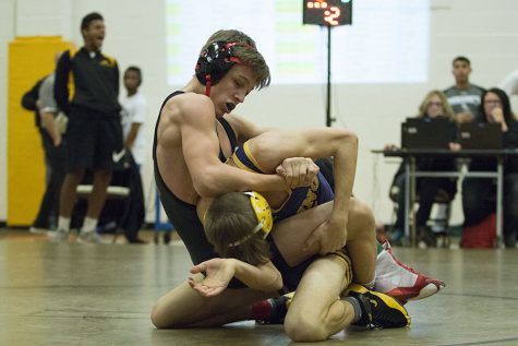 Schram works hard to take down his opponent in a early tournament at Blue Valley High