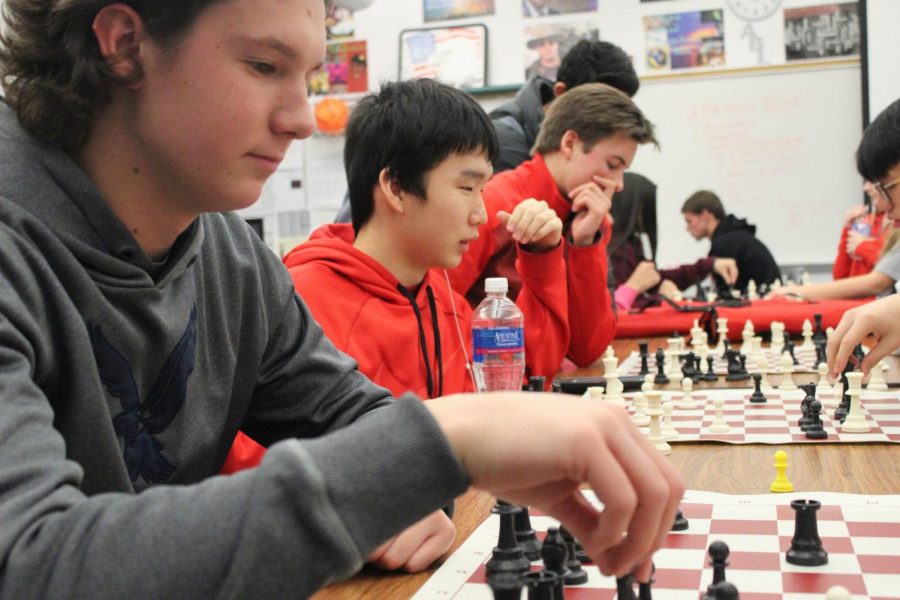 Check! Junior Matt Ronnebaum along with two other juniors contemplate their next moves carefully. Chess club has a wide array of students and some teachers who come and participate. 
