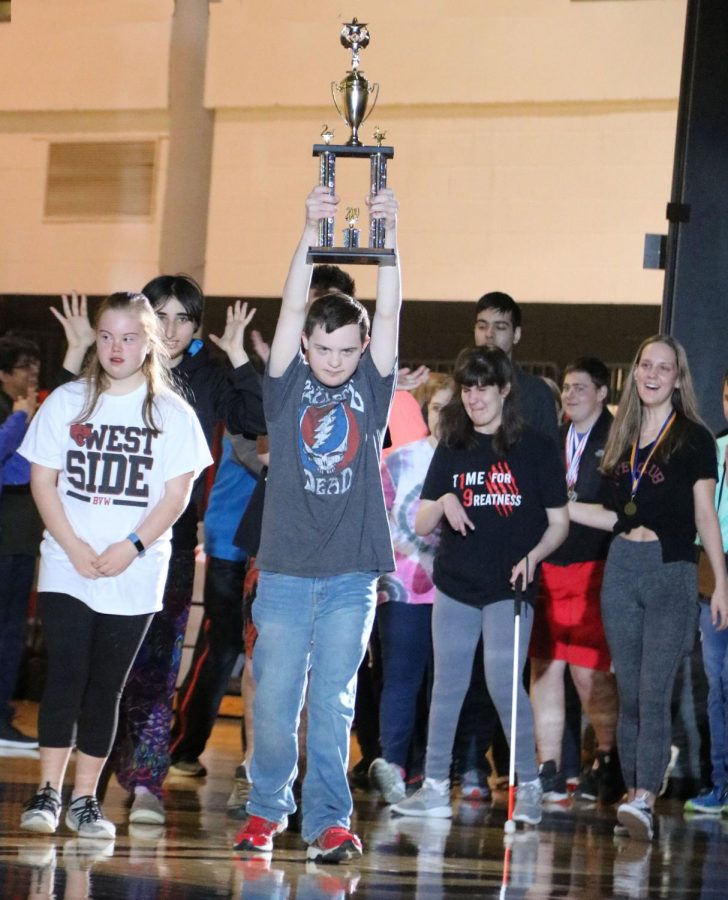 With the trophy held high, sophomore Fletcher Turner enters the April 23 assembly with the other members of the Job Olympics team. The group earned a second place finish at the competition on March 28. Students earned 15 medals competing against 12 other schools. The student body gave their peers a standing ovation.