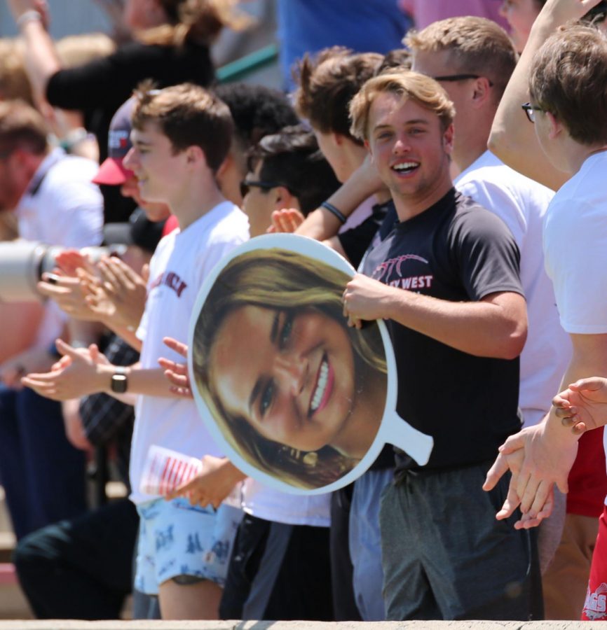 Jake Huxhold holds a fat head of forward Lindsi Bankers face to show support. Huxhold and more than 15 other senior boys came out to support the girls soccer team.