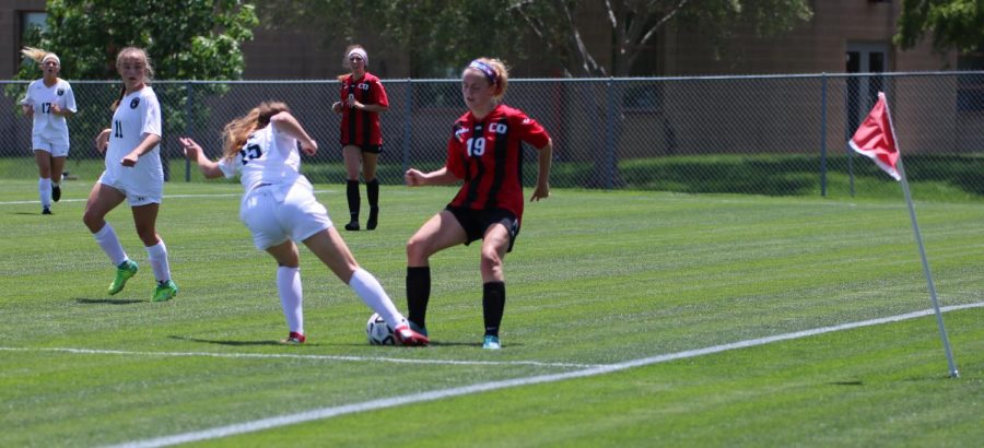 Ashlyn Acheson stops the SM South player from moving the ball forward in the State quarterfinal game on May 22.