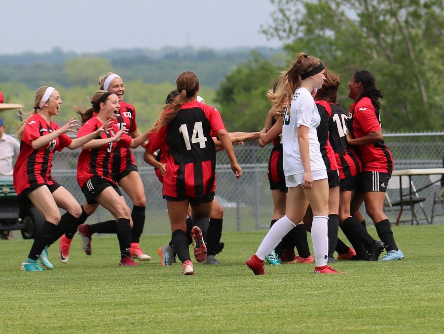Expressing their joy, girls soccer players run to embrace their teammates after winning the State quarterfinal game at the BV Antioch DAC on May 22.