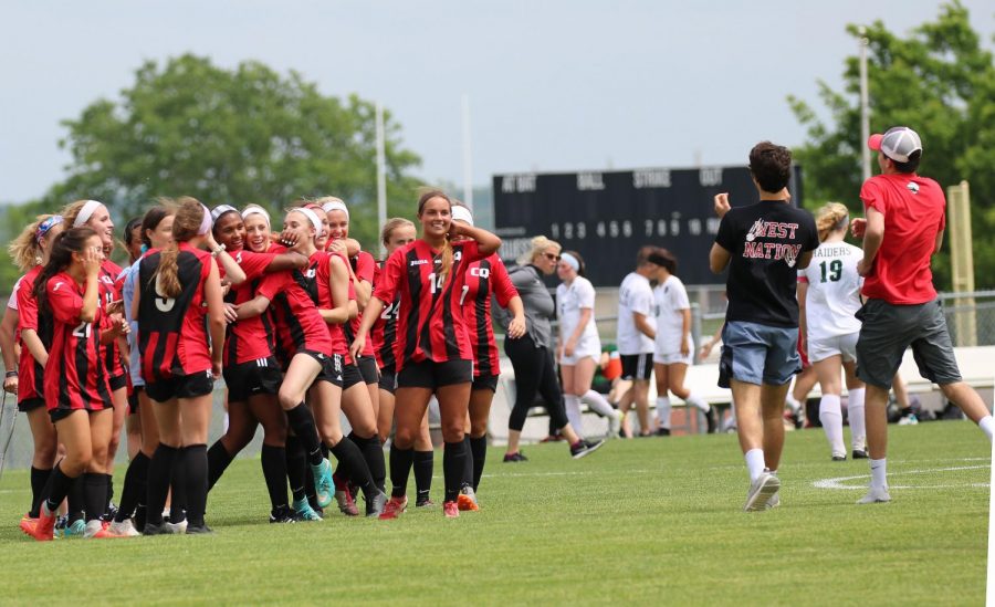 Continuing to congratulate each other and celebrate with friends, the girls soccer team relishes their third trip to the State semi-finals in as many years.