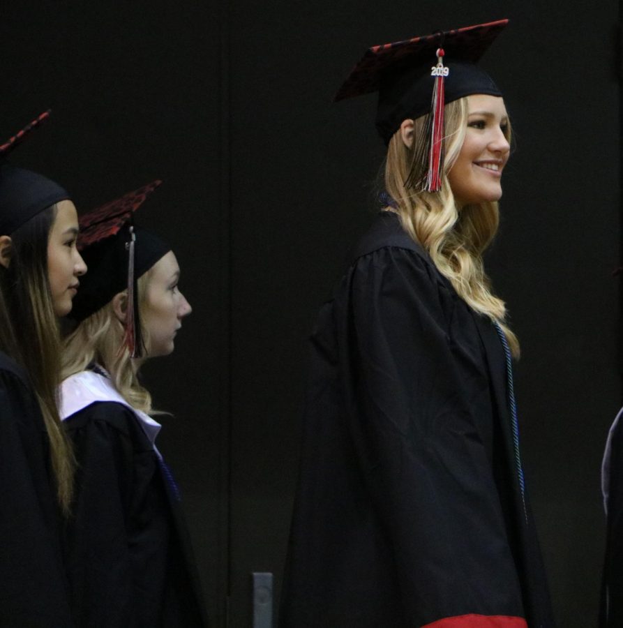 With a radiant smile, senior Lauren Lillis enters the gym on Class Day, May 10, 2019.