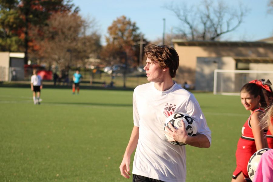 Holding the ball before making a throw-in, senior Brendan Mullen makes eye contact with a teammate.