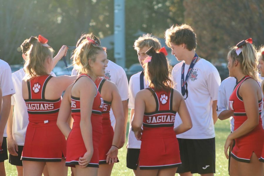 The varsity cheerleaders were tasked with placing the medals on the boys necks after the 6A championship game where the boys earned second.