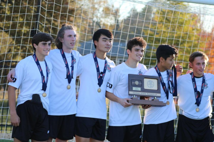 Boys soccer players show mixed emotions when accepting second place medals and trophy at State meet on Nov. 9 at Topekas Hummer Sports Complex.