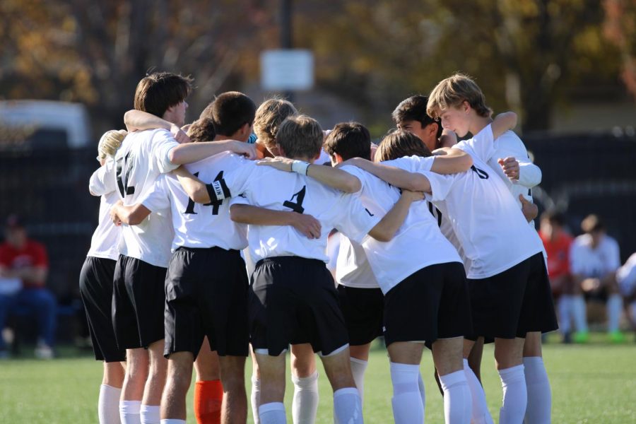 The boys soccer team huddles up before the 6A State championship soccer game on Nov. 9, 2019 in Topeka.