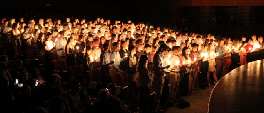 Once the light of knowledge is lit for each of the new inductees, they stand to take the honor pledge at the NHS Induction Ceremony on Nov. 7.
