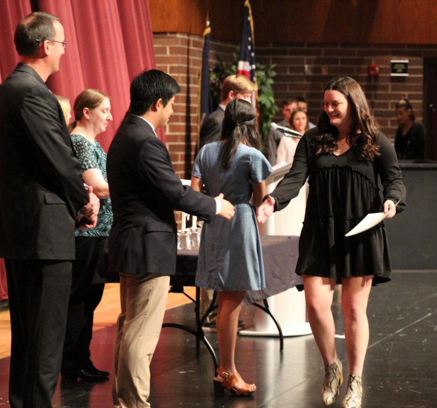 Junior Catherine Darche begins her congratulatory handshakes after being inducted into NHS.