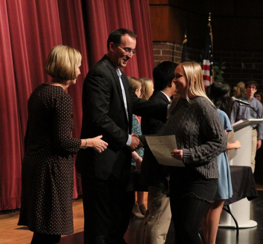 Sharing a moment with teachers Kevin Bandy and Karen Tritt, senior Libby Johnson becomes a member of NHS.