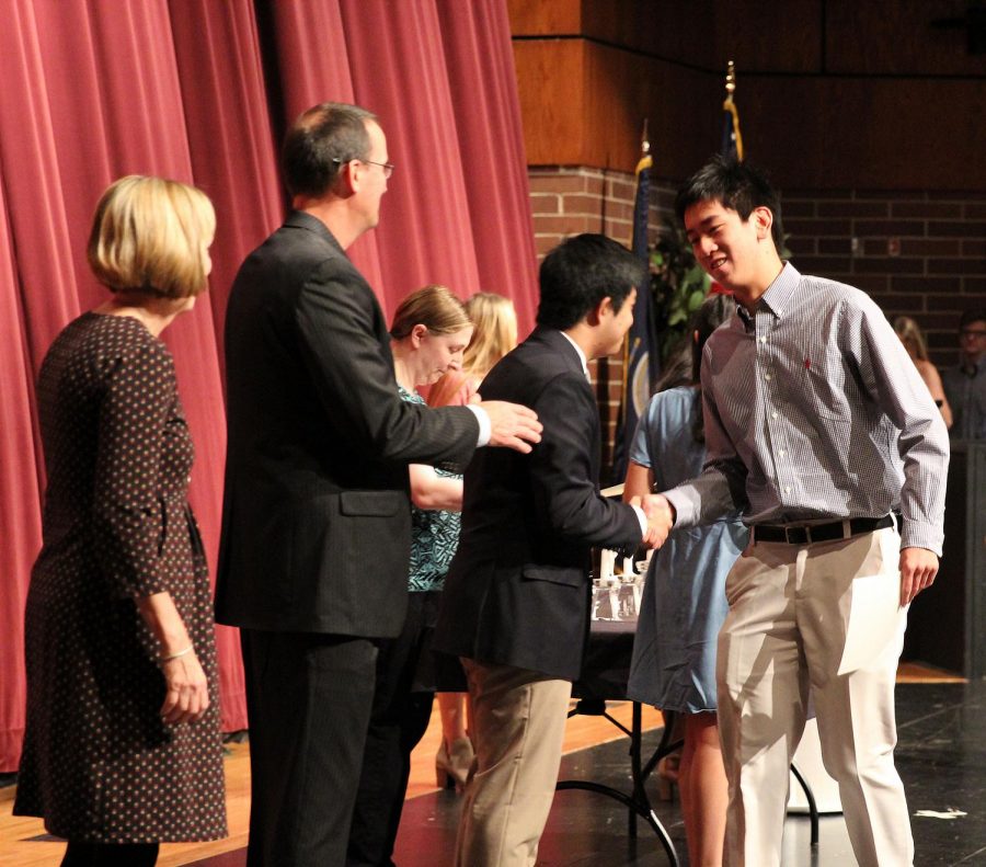 Junior Michael Linn accepts congratulations upon his induction into the NHS.