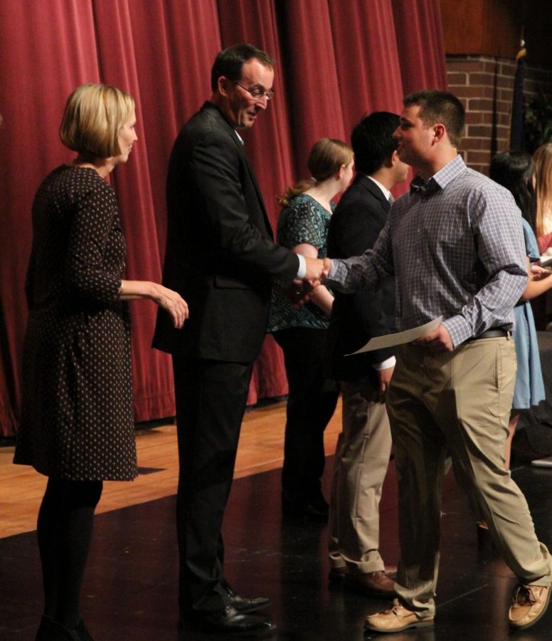 Teacher Kevin Bandy looks surprised that junior Jared Patterson met the qualification for NHS. Bandys sense of humor was one of the reasons he was asked to attend the ceremony.