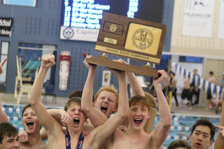 Swim+team+members+celebrate+their+6A+State+Championship+over+Olathe+East+on+Feb.+22.