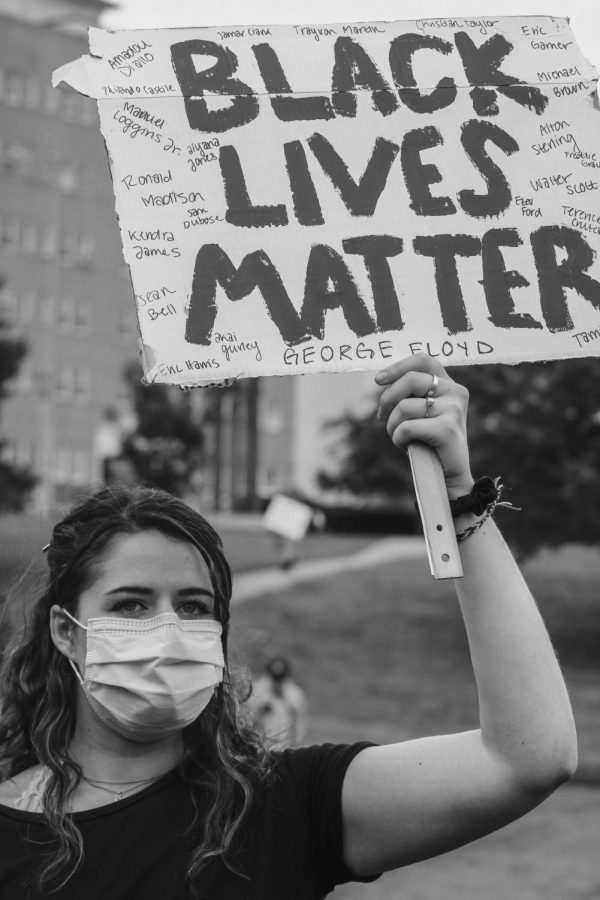 A+young+woman+holds+a+Black+Lives+Matter+sign+with+the+names+of+black+men+and+women+killed+by+police+officers+in+the+United+States.+She+was+participating+in+a+March+for+Justice+on+May+31+in+Kansas+Citys+Country+Club+Plaza.+The+demonstration+began+peacefully+but+escalated+to+violence+and+looting.+Police+attempted+to+disperse+the+crowd+with+pepper+spray%2C+rubber+bullets+and+tear+gas.