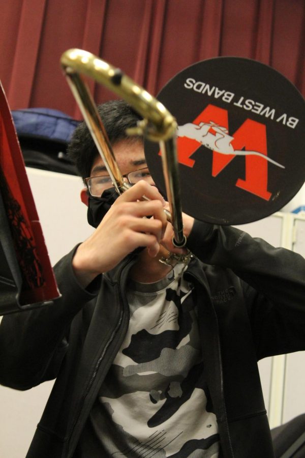 Students+playing+brass+instruments+must+wear+specialized+masks+on+their+faces+and+the+end+of+their+instruments.