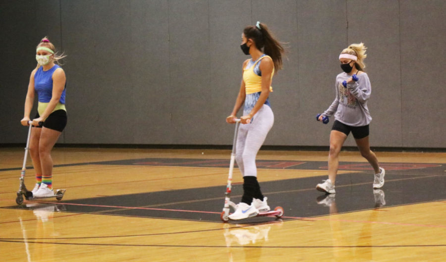 JPCo memebers Reiss Wood, Katherine Soule, and Maleigha Vietti, travel across the gym during freshman orientation.