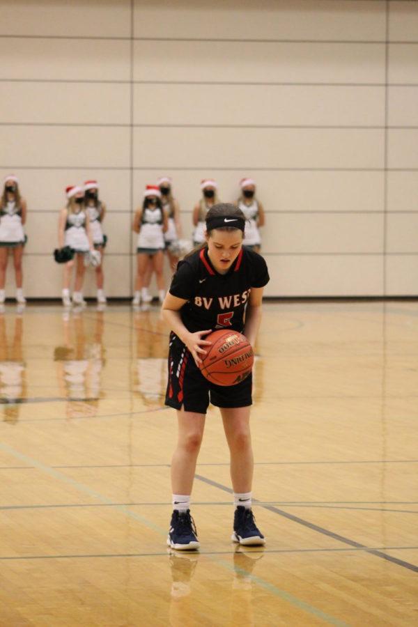 Varsity basketball player Olivia Legate prepares to shoot a free throw.