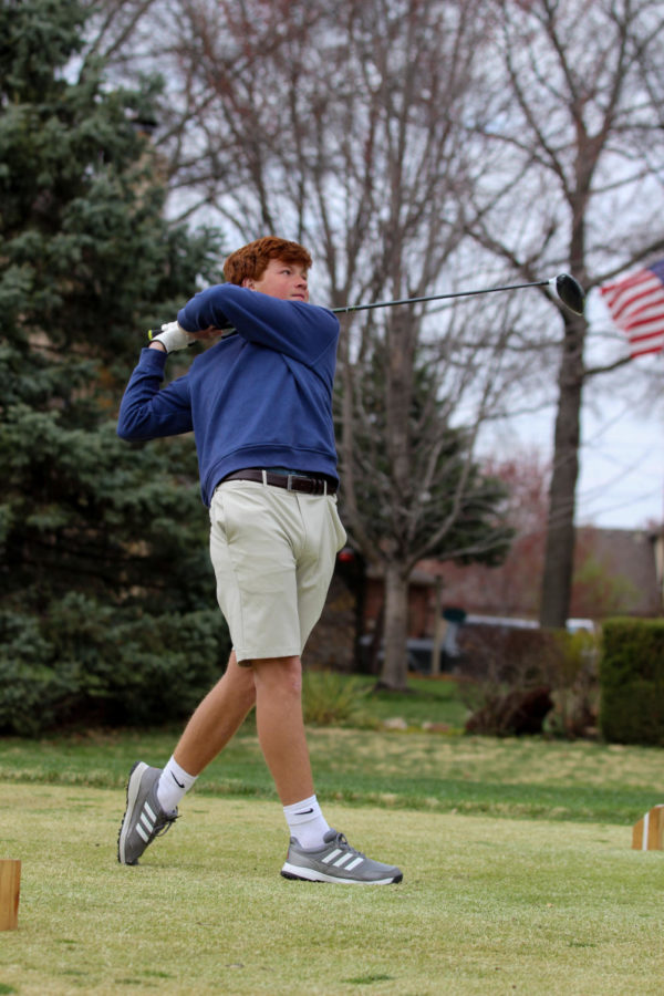 Freshman Mitchell Arensburg swings hard in the Boys Golf duel vs. BV on Mar.30