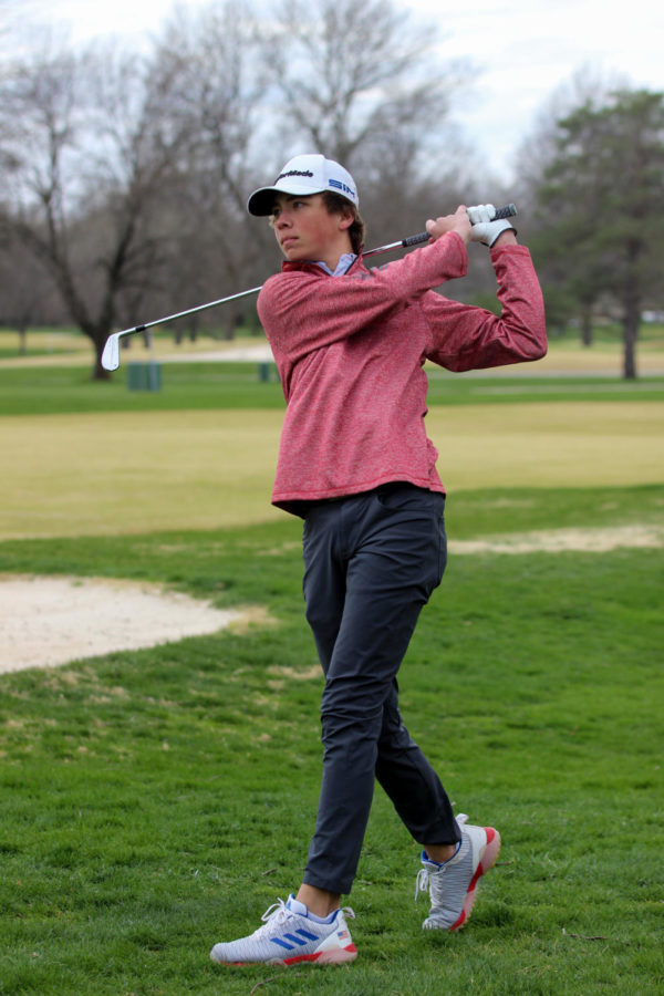 Freshman Carson Shlup swings in the Boys Golf duel vs. BV on Mar. 30