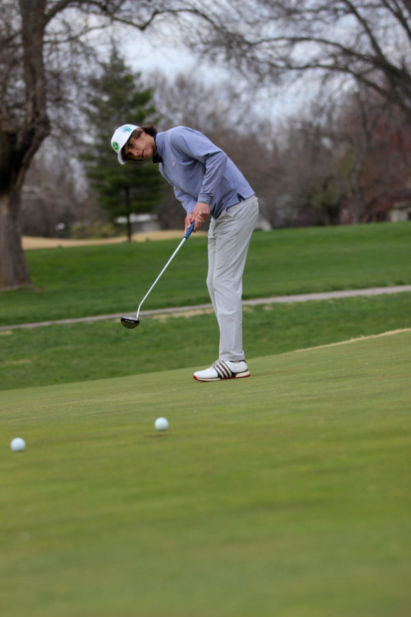 Junior Evan Bennett puts right into the hole during the Boys Golf duel vs. BV on Mar. 30