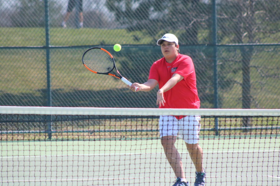 All eyes on the ball as BVW tennis player swings at the ball.