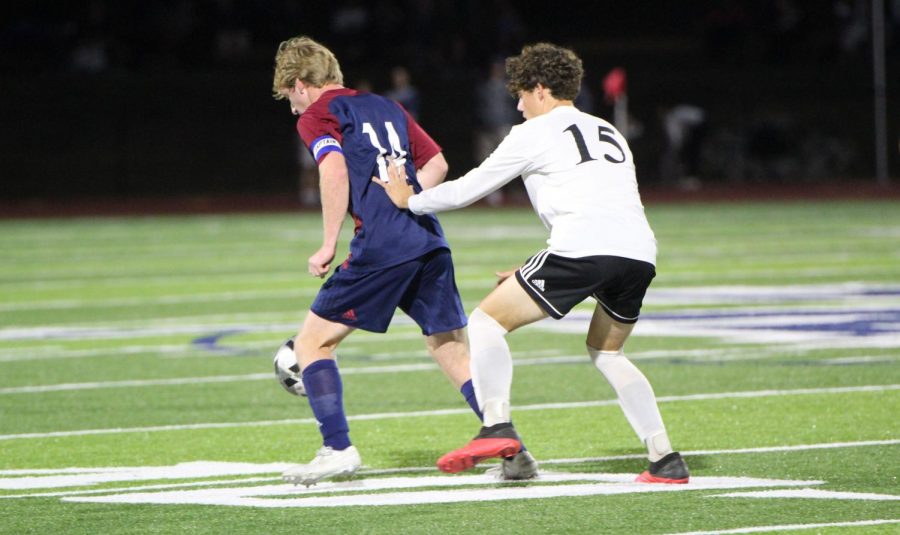 Senior Connor Plant defends the ball in the game against Saint James.