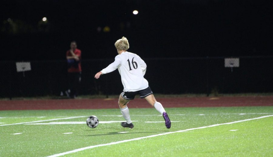 Senior Drew Newbold begins to make a pass in the game against Saint James.