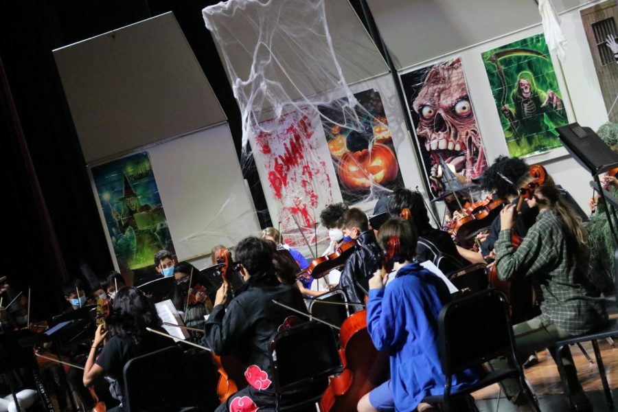 The Orchestra is playing a song with the spooky background design.