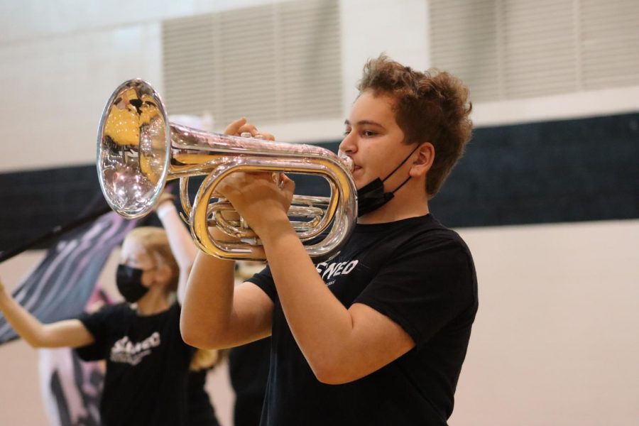 Sophomore Silas Baldwin plays his baritone during the marching bands performance, Skewed. 