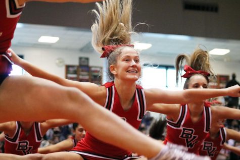 Junior Olivia Brokaw performs with the BVW cheer team at the pep assembly. 