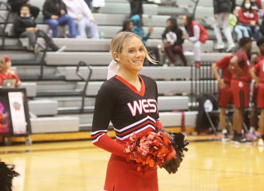 Senior Linsey Cramer is cheering at the basketball game.