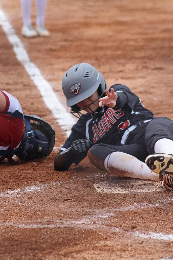 Sophomore Bethany Burt slides into home plate and scores for the Jaguars. 
