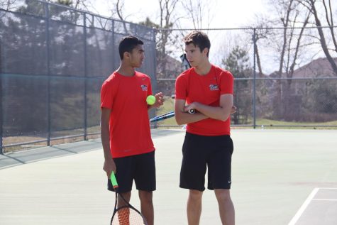 Planning a win, senior Jack Contrucci and freshman Ethan Kumar discuss their playing in between games on March 28th. 