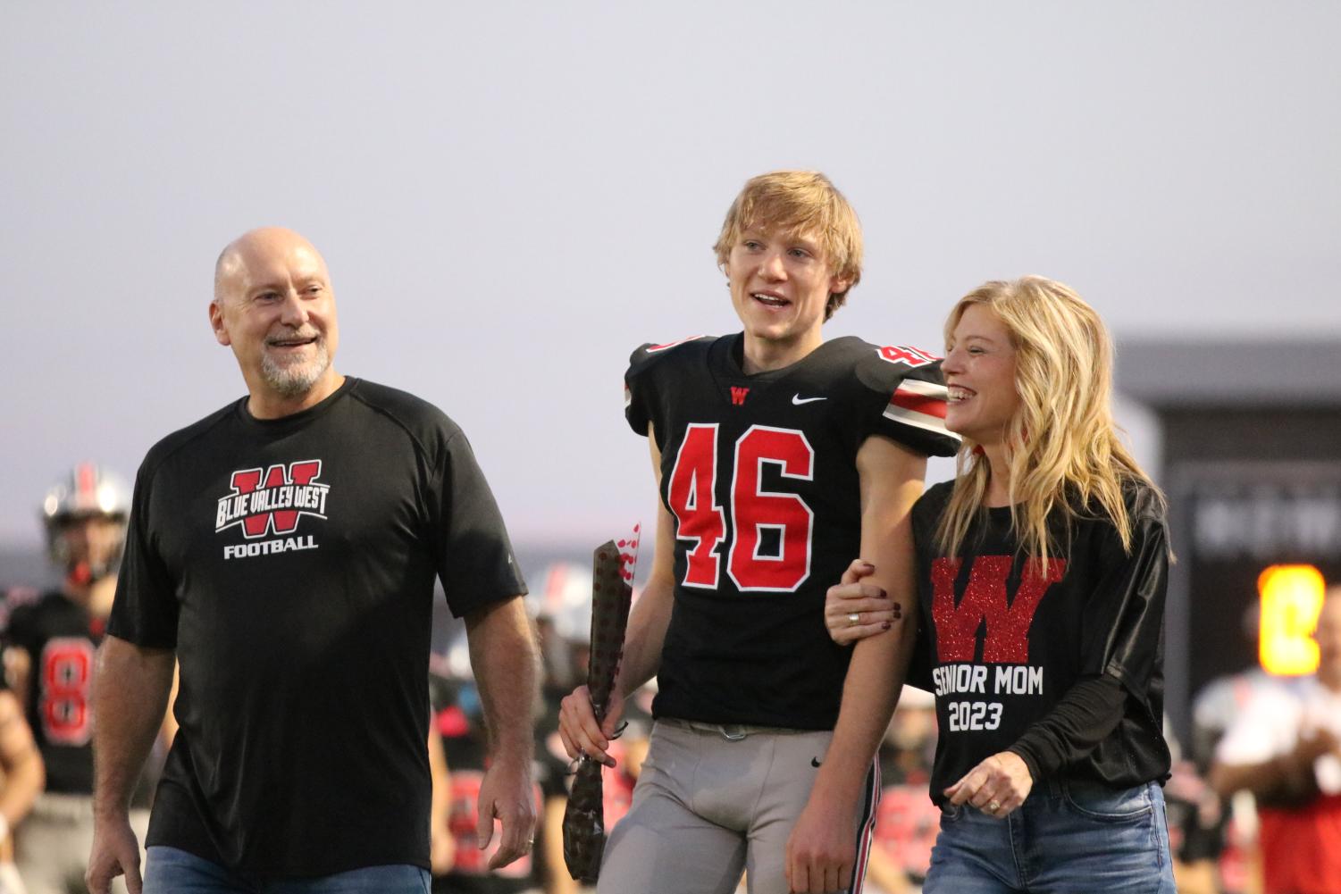 Walking with his parents, senior Dan McCabe gets recognized at footballs senior night on Oct. 12.