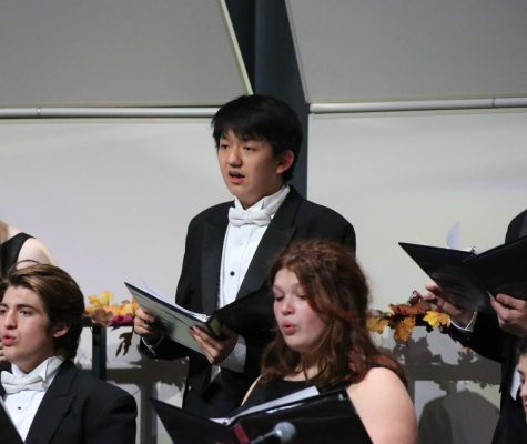 Junior Vince Li reads his music while performing with the Chamber Singers.