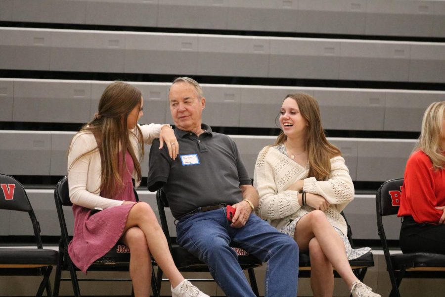 Kate and Kailey Dewitt speaking with their veteran grandparent before the assembly starts