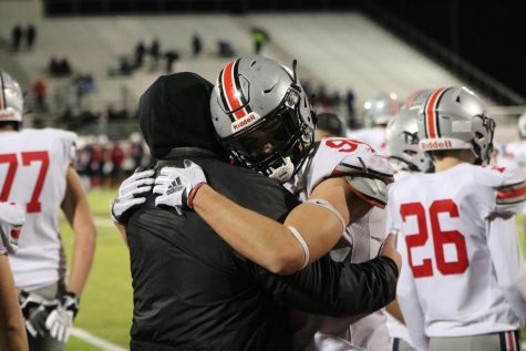 Nico Cocumelli hugs coach as the jaguars celebrate their win against ON.