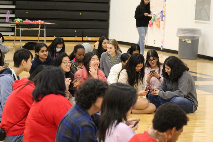 Asian multicultural club members gather on the floor of the gym to talk during their festival!