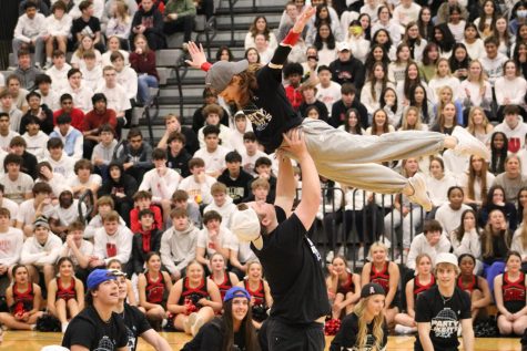 Seniors Ashley Benson and Ari Shaft soar above as he lifts her in the air