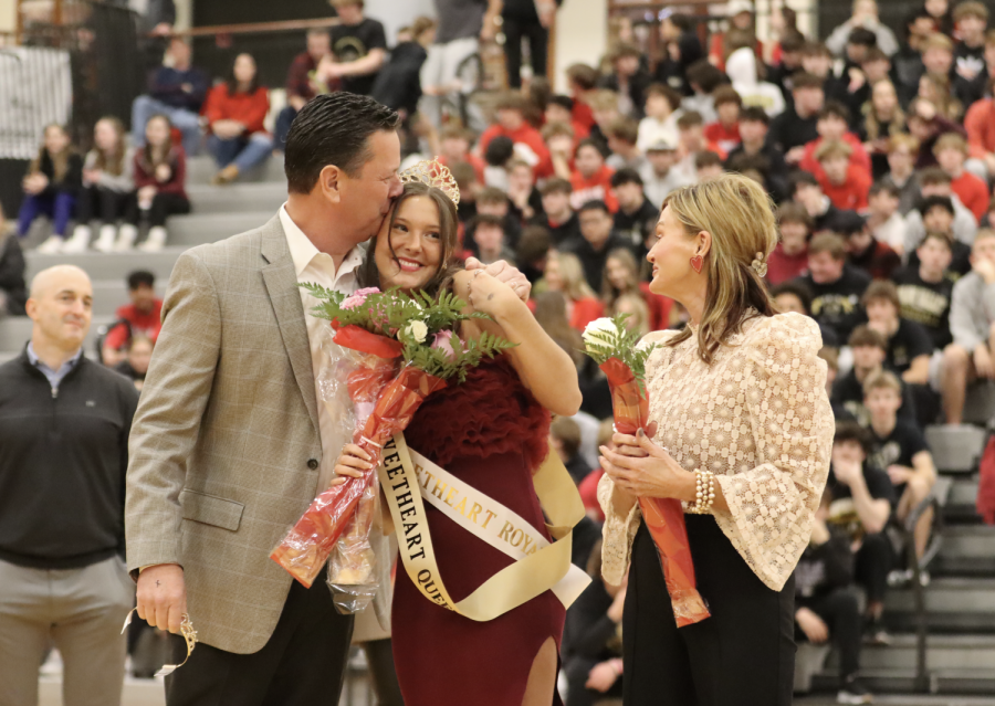 Rylee Burns smiles as her dad proudly kisses her head as she is announced Sweetheart Queen