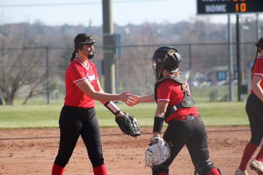 Junior Sarah Buehler is congratulated by the catcher after a great pitch.  