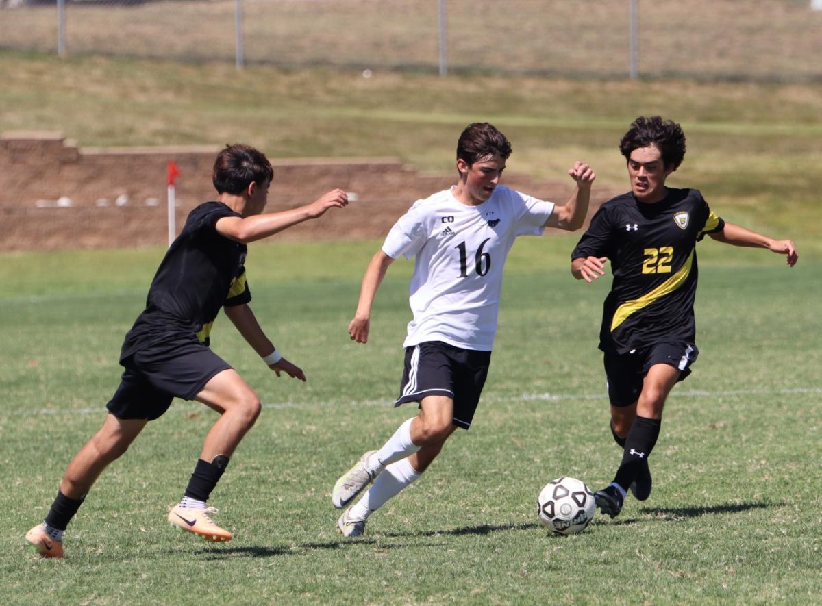 Sophomore, Colsen Odgers breaks through the tight defense of his opponents with the ball at his feet.