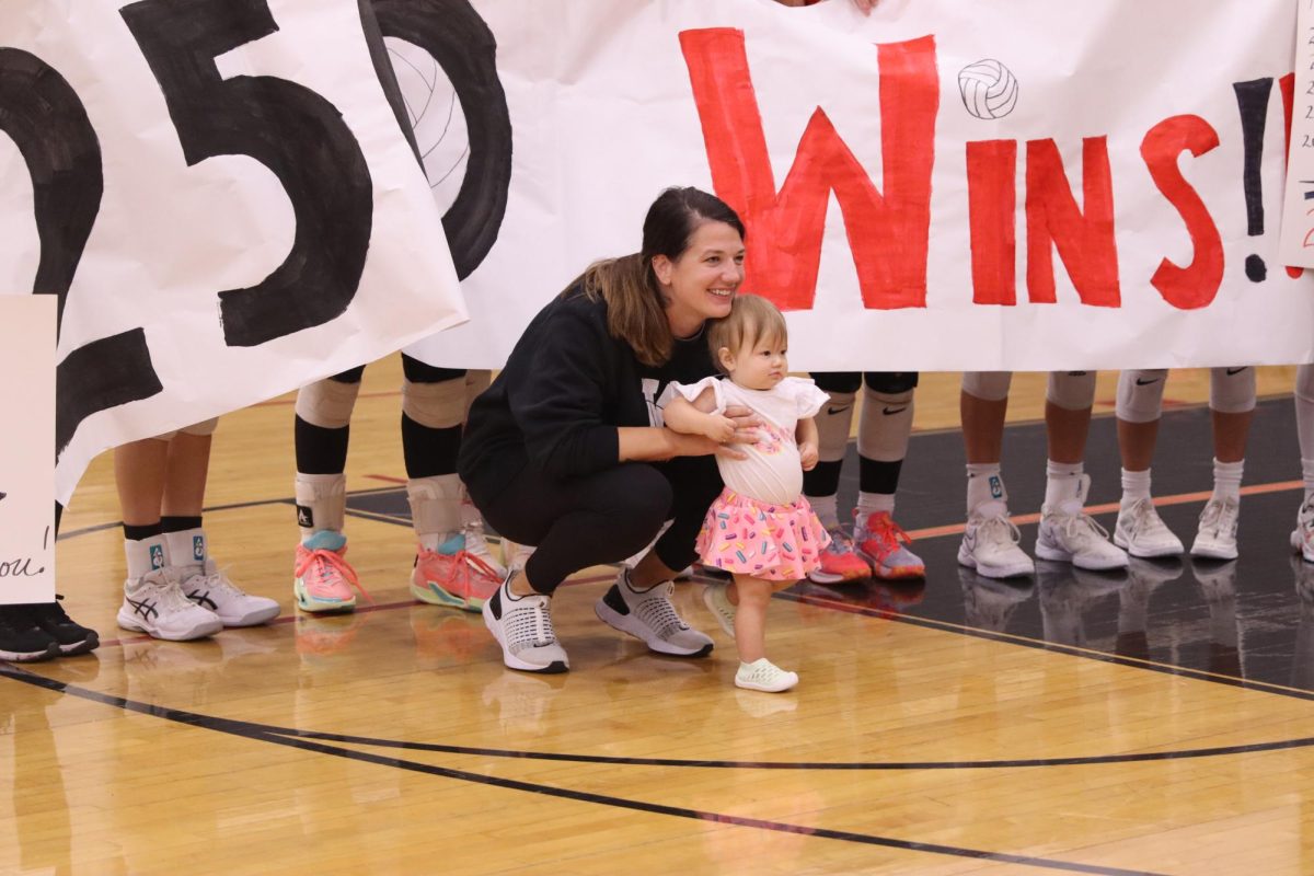 Coach Horstick and her baby smile for her 250th win.